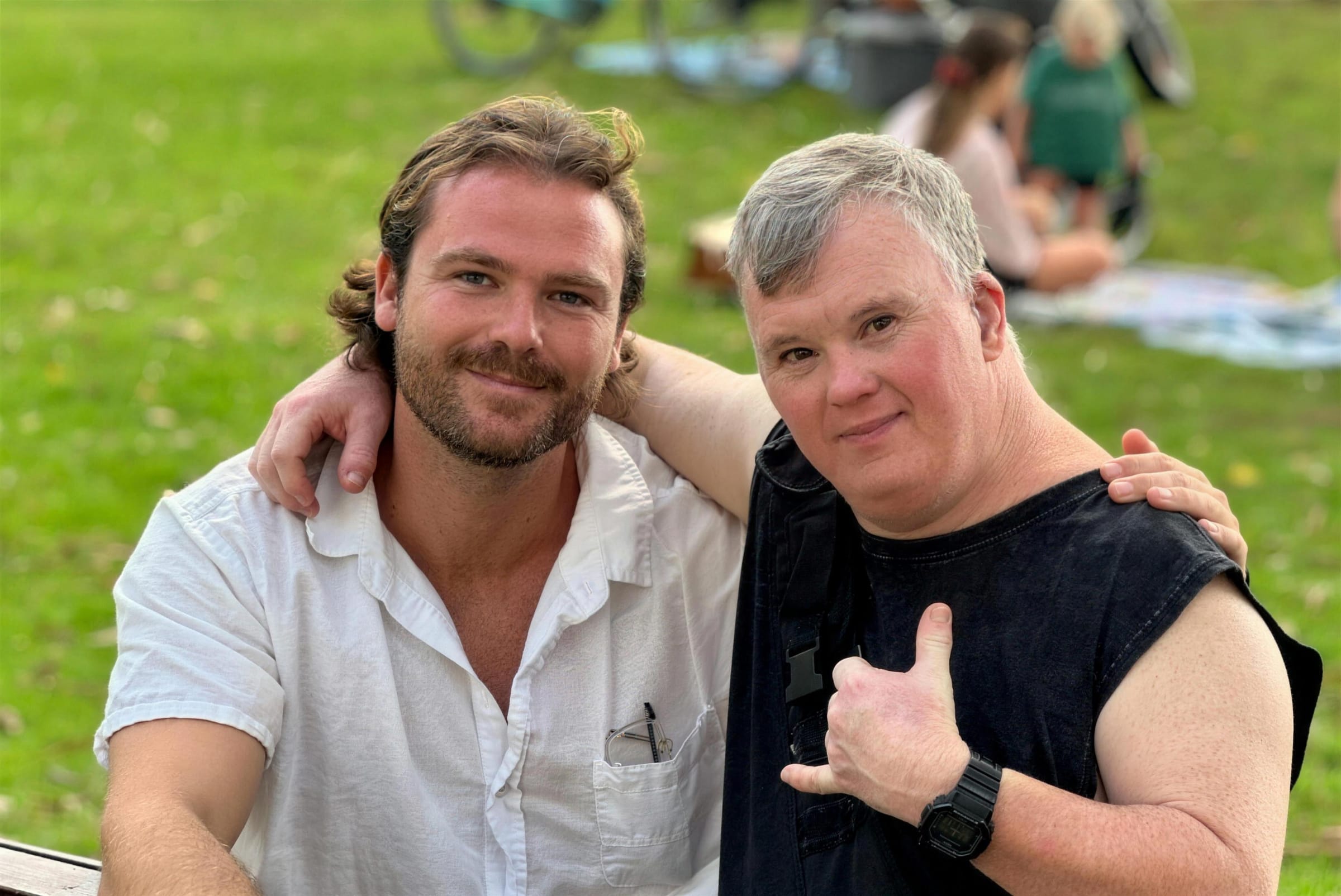 Two people sitting together in a park