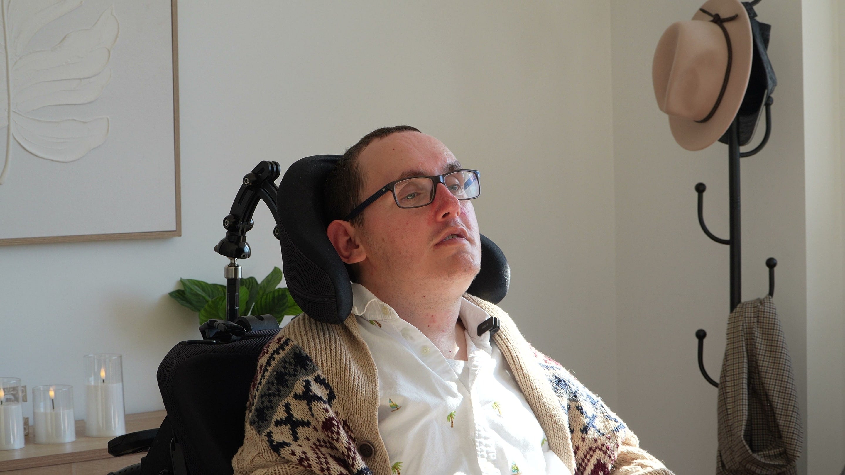 A wheelchair user sitting in a bright living room