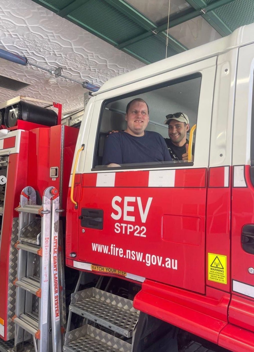 A person sitting in a red fire truck